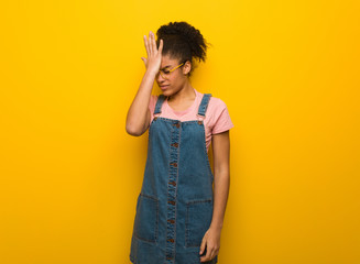 Young black african american girl with blue eyes forgetful, realize something
