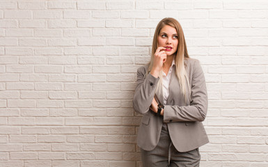 Young russian business woman relaxed thinking about something looking at a copy space