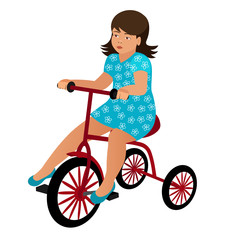 Little cute girl in a blue summer dress with a floral pattern is sitting on a red tricycle. Child rides baby bike on a white background. Vector illustration.
