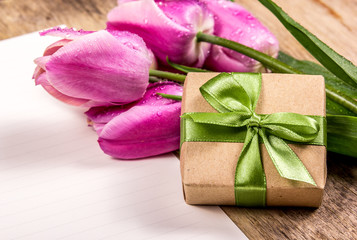 Gift box with bow. Gift box and tender pink tulips