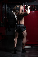 Fototapeta na wymiar Muscular Men Is Hitting Rear Double Bicep Pose