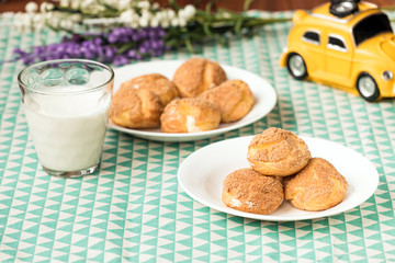 There are delicious puffs and milk on the table