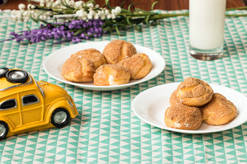 There are delicious puffs and milk on the table