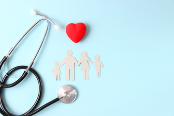 stethoscope and heart on a colored background top view. Family medicine