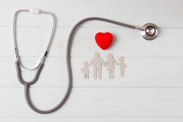 stethoscope and heart on a colored background top view. Family medicine