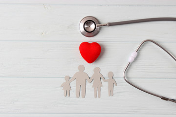 stethoscope and heart on a colored background top view. Family medicine