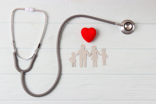 Stethoscope And Heart On A Colored Background Top View. Family Medicine