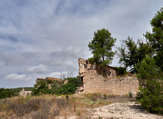 Fototapeta na wymiar Country house abandoned and occupied by brush, in the vicinity of Fontanars dels Aforins, Spain