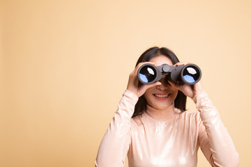Young Asian woman with binoculars.