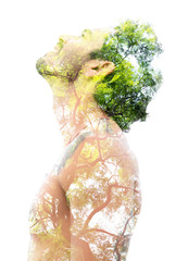 Double exposure of a young bare-chested man’s portrait blended with bright green leaves, showing...
