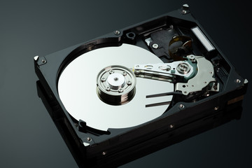 Hard drive from the computer hdd with mirror effect. Close-up, macro, on a black background.