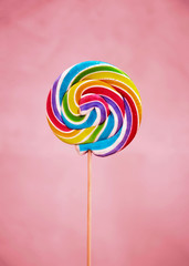 Colorful lollipop on pink background