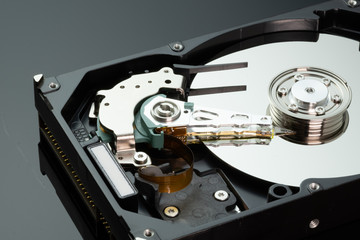 Hard drive from the computer hdd with mirror effect. Close-up, macro, on a black background.