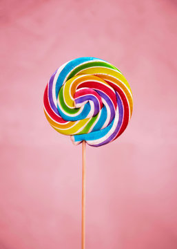 Colorful lollipop on pink background