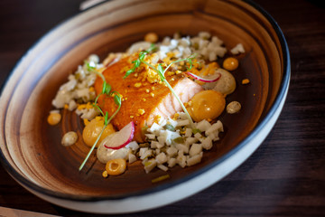 Fillet of salmon Steak grilled pepper , Grains , herbs, lemon, garlic, olive oil, and salt .  Fish for healthy dinner.