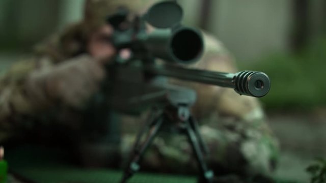 Hit the target. Sniper is preparing for apt shot. Special agent performs secretory mission .