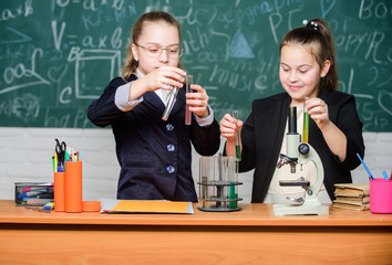 Inspire. Little girls scientist with microscope. Biology lab. Happy Genius. Little girls genius in school lab. Science lab. science experiments in laboratory. Chemistry research in laboratory