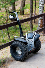 Segway with protective helmet against the background of green forest. Close-up