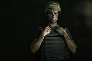 Giving a promise to mum. Half-lenght portrait of young male soldier. Man in military uniform on the...