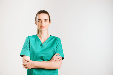 Cheerful female doctor in green uniform.