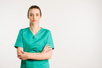 Cheerful female doctor in green uniform.