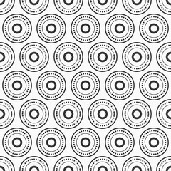 Abstract seamless vector pattern with black dotted circles, rings isolated on white background.