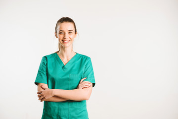 Cheerful female doctor in green uniform. - obrazy, fototapety, plakaty