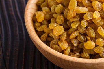 golden raisins on a wooden rustic background