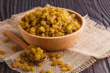 golden raisins on a wooden rustic background