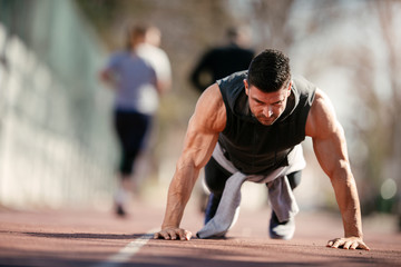 Fitness woman doing push ups on a yoga mat