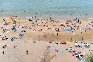 People on the beach of Playa de Matalenas, Cantabria, Santander, Spain