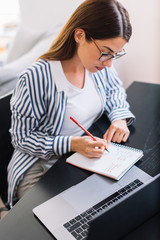 Businesswoman taking notes. Young student preparing exam. 