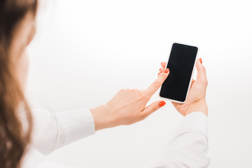 selective focus of woman using smartphone with blank screen on white background