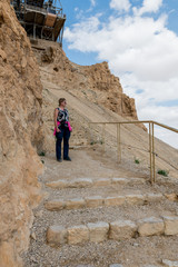 womam walking from masada mountain