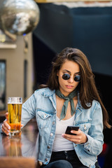 Beautiful woman having beer at the bar.