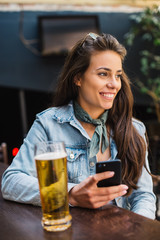 Beautiful woman having beer at the bar.