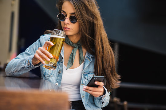 Beautiful Woman Having Beer At The Bar.