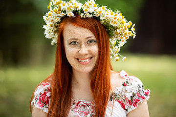 Portrait of a redhead girl with a wreath