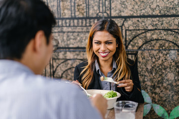 Portrait of a two young,poised professionals Asian business people having lunch in a restaurant in...