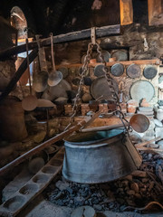 Ancient utensils and hearth with a boiler in the ancient kitchen in the Megala Meteora monastery in...