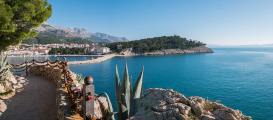 Makarska city port entrance and calm blue sea - obrazy, fototapety, plakaty