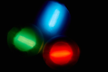 red blue and green light spots on a black background