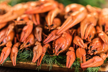 Pile of boiled crayfish on rustic wooden background