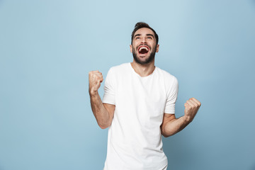 Cheerful excited man wearing blank t-shirt standing