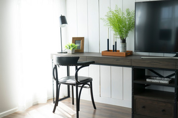 Wooden table or desk with a chair in a room