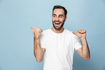 Cheerful excited man wearing blank t-shirt standing