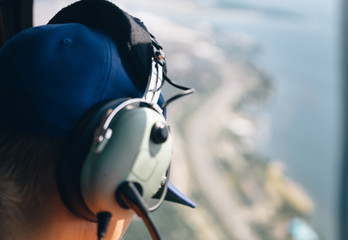 Fototapeta premium Man looks out of helicopter window