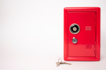 red safe on white background. bank with key.