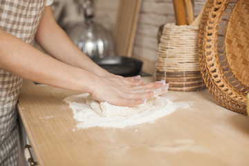 Woman`s hands making dough. Housewife kneading the dough. Chef cooking. background.