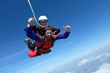 Tandem skydiving. Two happy men are in the sky.